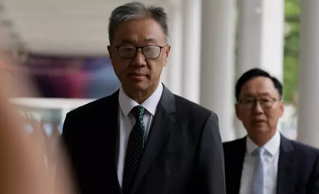 David Lok, chairman of the Independent Committee, arrives for the closing submissions at the Independent Commission investigation hearing into last year's Tai Po deadly fire, in Hong Kong, Friday, July 17, 2026. (AP Photo/May James)