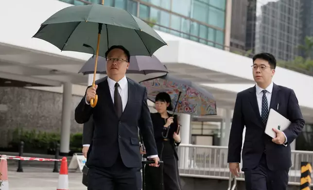 Jenkin Suen, counsel for the Hong Kong government, arrives for the closing submissions at the Independent Commission investigation hearing into last year's Tai Po deadly fire, in Hong Kong, Friday, July 17, 2026. (AP Photo/May James)