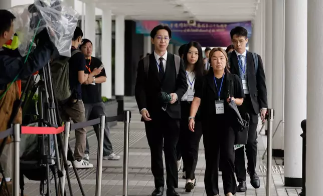 Members of Independant Commission team arrives for the closing submissions at the Independent Commission investigation hearing into last year's Tai Po deadly fire, in Hong Kong, Friday, July 17, 2026. (AP Photo/May James)