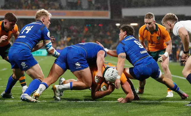 Australia's Josh Canham , center, score the first try against Italy during their Nations Championship rugby international test match in Perth, Australia, Saturday, July 18, 2026. (AP Photo/Gary Day)