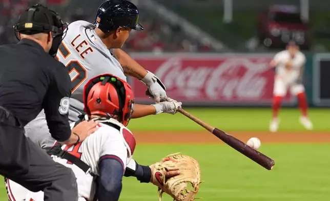 Detroit Tigers' Hao-Yu Lee, center, hits a two RBI double as Los Angeles Angels catcher Logan O'Hoppe, right, and home plate umpire Will Little watch during the ninth inning of a baseball game Friday, July 17, 2026, in Anaheim, Calif. (AP Photo/Mark J. Terrill)