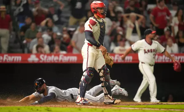 Detroit Tigers' Riley Greene, left, scores on a double by Hao-Yu Lee as Los Angeles Angels catcher Logan O'Hoppe stands by during the ninth inning of a baseball game Friday, July 17, 2026, in Anaheim, Calif. (AP Photo/Mark J. Terrill)