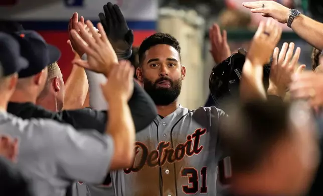 Detroit Tigers' Riley Greene is congratulated by teammates in the dugout after scoring on a double by Hao-Yu Lee during the ninth inning of a baseball game against the Los Angeles Angels, Friday, July 17, 2026, in Anaheim, Calif. (AP Photo/Mark J. Terrill)