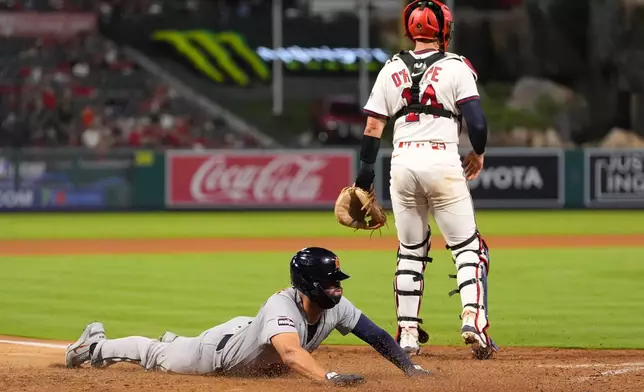 Detroit Tigers' Riley Greene, left, scores on a double by Hao-Yu Lee as Los Angeles Angels catcher Logan O'Hoppe stands by during the ninth inning of a baseball game Friday, July 17, 2026, in Anaheim, Calif. (AP Photo/Mark J. Terrill)