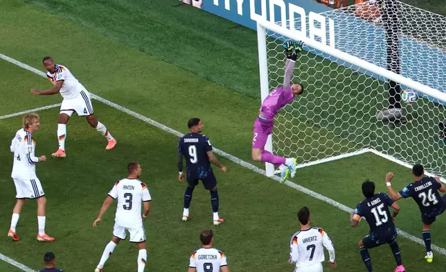 Paraguay goalkeeper Orlando Gill (12) fails to save a goal that was disallowed by Germany's Jonathan Tah (4) as Paraguay's Antonio Sanabria (9) looks on during the World Cup round of 32 soccer match between Germany and Paraguay in Foxborough, Mass., near Boston, Monday, June 29, 2026. (AP Photo/Mark Stockwell)