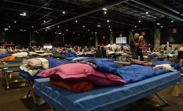 Camp beds for evacuees are laid out in a temporary shelter in Bordeaux, France, Tuesday, July 28, 2026, for some of the 220,000 people who have fled wildfires in France's southwest Gironde region. (AP Photo/Eva van Dam)