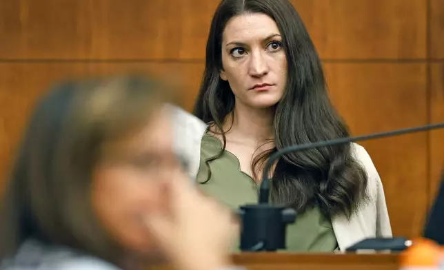 Lindsay Clancy waits for the judge to call a prospective jury member into court in her murder trial where she is charged in the 2023 killing of her three children, Wednesday, July 22, 2026, in Plymouth Superior Court in Plymouth, Mass. (Greg Derr/The Patriot Ledger via AP, Pool)