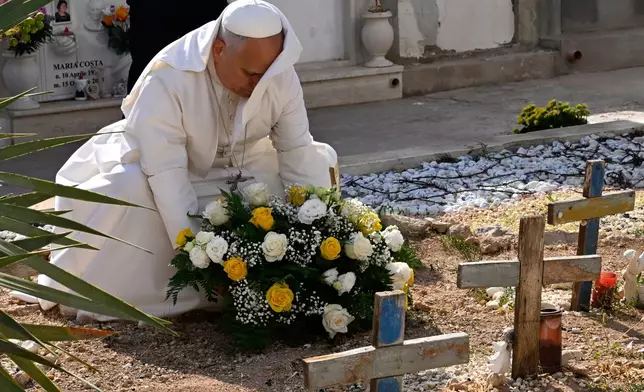 Pope Leo XIV pays tribute at the cemetery and on little Joussef's grave, in Lampedusa, Sicily, southern Italy, Saturday, July 4, 2026, during a one-day pastoral visit to an island that has become a symbol of the risks faced by migrants trying to reach Europe by sea.(Pool Photo/Ciro Fusco, Via AP)
