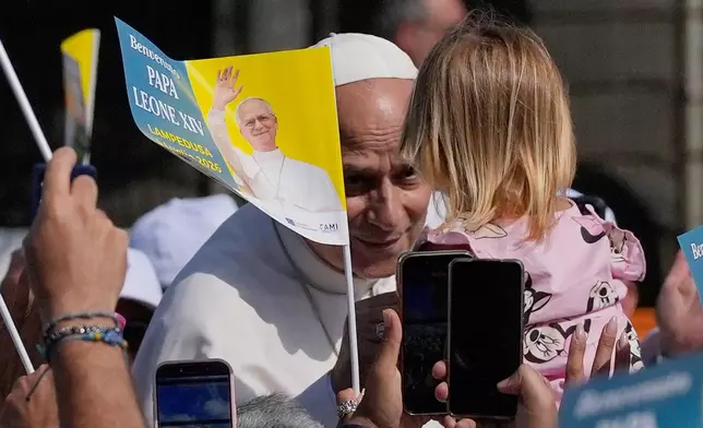 Pope Leo XIV arrives to celebrate Mass in Lampedusa, Sicily, southern Italy, Saturday, July 4, 2026, during a one-day pastoral visit to the Sicilian island that has come to symbolize the dramatic odyssey of migrants trying to reach Europe by sea. (AP Photo/Alessandra Tarantino)