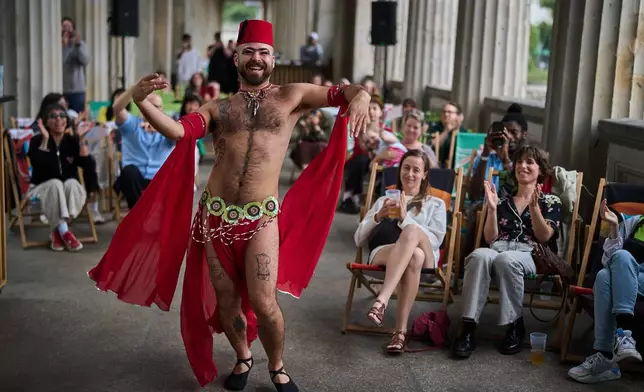 Haidar Darwish, a Syrian belly dancer with the Berlin-based LGBTQ collective Queens Against Borders, performs during an open-air show in Berlin, Germany, Sunday, July 26, 2026. (AP Photo/Ebrahim Noroozi)