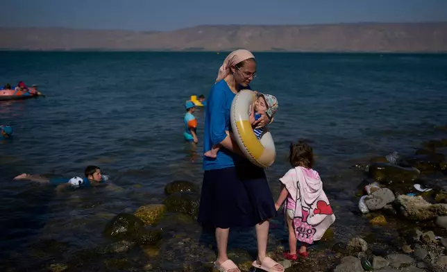 People bathe in the Sea of Galilee in northern Israel, Wednesday, July 29, 2026. (AP Photo/Ohad Zwigenberg)