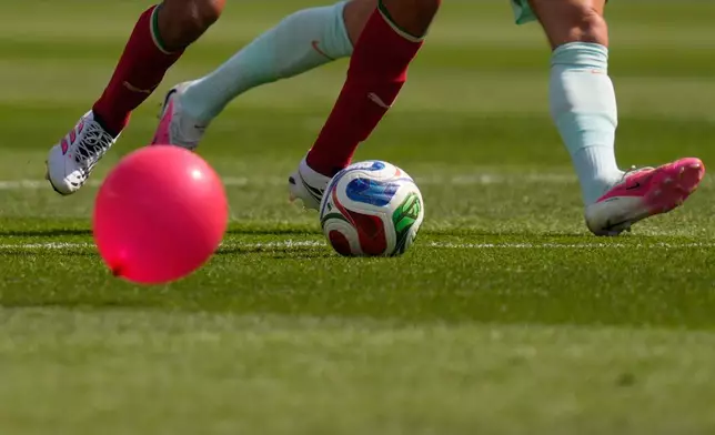 A balloon floats on the field as Morocco's Ayyoub Bouaddi, left, battles for the ball with France's Adrien Rabiot during the World Cup quarterfinal soccer match between France and Morocco in Foxborough, Mass., near Boston, Thursday, July 9, 2026. (AP Photo/Charles Krupa)