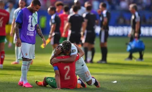 Morocco's Achraf Hakimi (2) and France's Desire Doue (20) hug after the World Cup quarterfinal soccer match between France and Morocco in Foxborough, Mass., near Boston, Thursday, July 9, 2026. (AP Photo/Steven Senne)