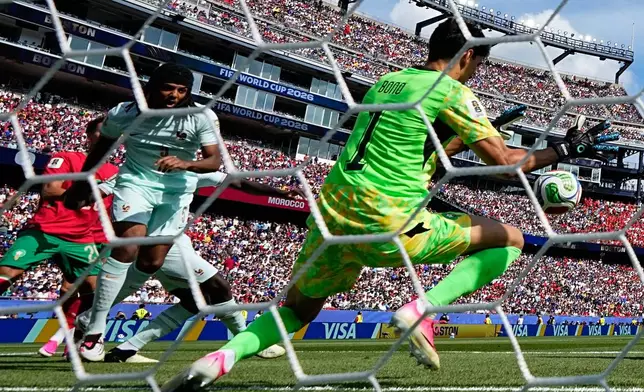 Morocco goalkeeper Sassine Bounou (1) makes a save during the World Cup quarterfinal soccer match between France and Morocco in Foxborough, Mass., near Boston, Thursday, July 9, 2026. (AP Photo/Martin Meissner)