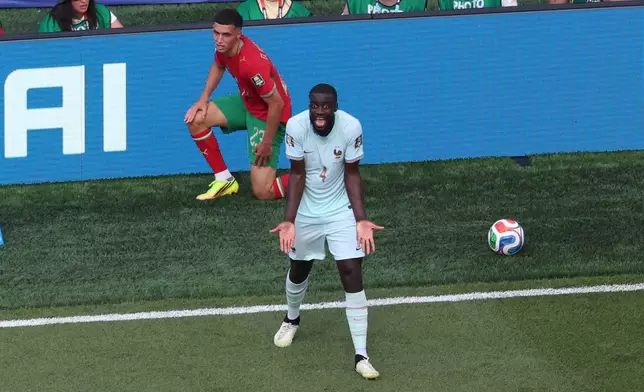 France's Dayot Upamecano (4) reacts after being called for a penalty against Morocco's Bilal El Khannouss (23) during the World Cup quarterfinal soccer match in Foxborough, Mass., near Boston, Thursday, July 9, 2026. (AP Photo/Mark Stockwell)