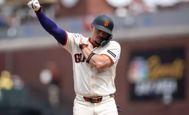 San Francisco Giants' Willy Adames reacts after hitting a single during the eighth inning of a baseball game against the Colorado Rockies, Sunday, July 12, 2026, in San Francisco. (AP Photo/Thien-An Truong)