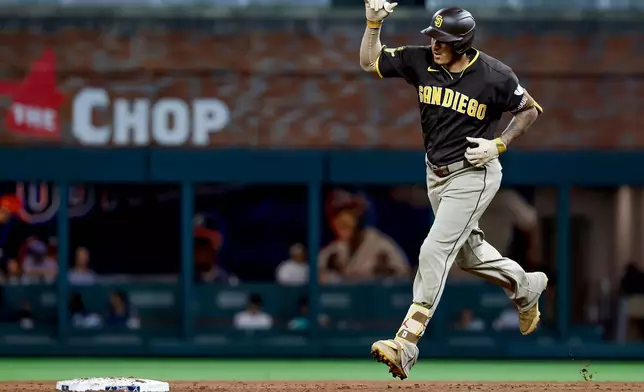 San Diego Padres' Manny Machado reacts while rounding the bases after hitting a solo home run against the Atlanta Braves during the sixth inning of a baseball game, Tuesday, July 21, 2026, in Atlanta. (AP Photo/Erik S. Lesser)