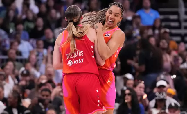 Team Coop's Gabby Williams, right, celebrates with Paige Bueckers after she scored a three-point basket during the first half of a WNBA All-Star basketball game against Team Spoon in Chicago, Saturday, July 25, 2026. (AP Photo/Nam Y. Huh)