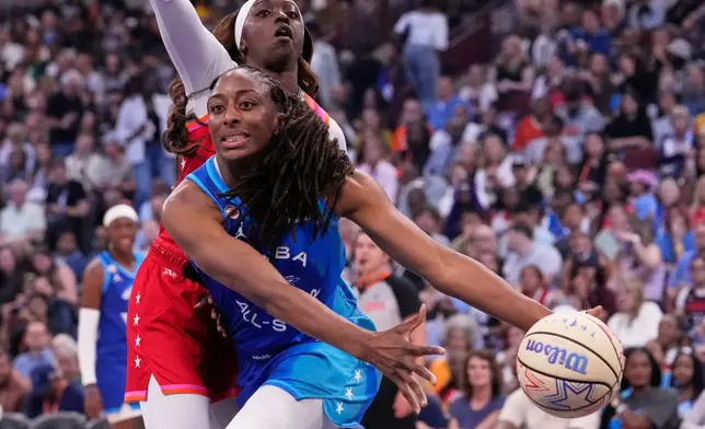 Team Spoon's Nneka Ogwumike, front, looks to pass the ball against Team Coop's Kahleah Copper, top, during the first half of a WNBA All-Star basketball game in Chicago, Saturday, July 25, 2026. (AP Photo/Nam Y. Huh)
