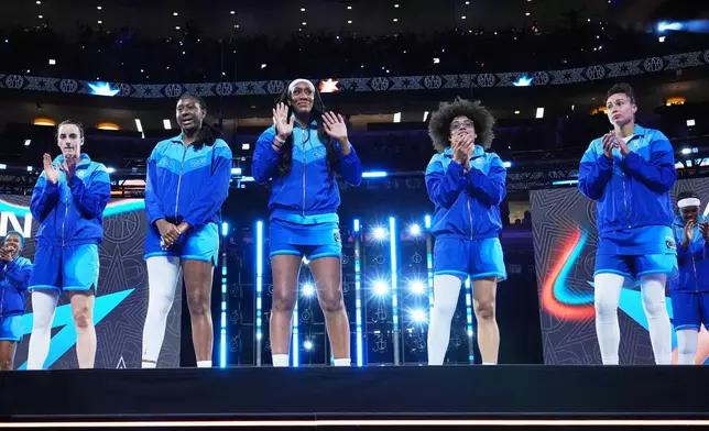 Left to right; Team Spoon's Caitlin Clark, Aliyah Boston, A'Ja Wilson, Olivia Miles and Jessica Shepard greet fans before a WNBA All-Star basketball game against Team Coop in Chicago, Saturday, July 25, 2026. (AP Photo/Nam Y. Huh)