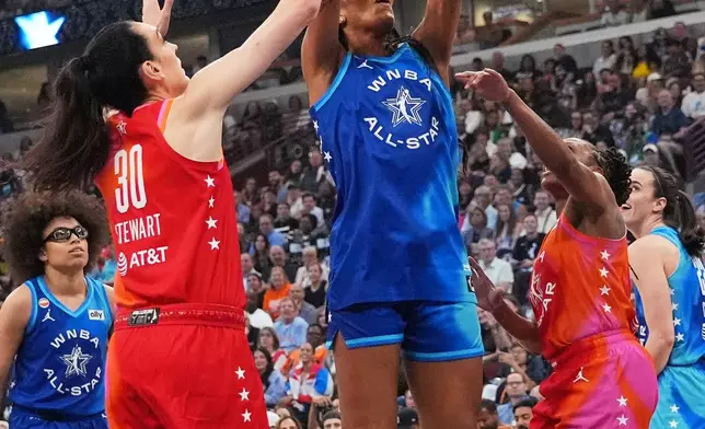 Team Spoon's A'Ja Wilson, center, goes up to shoot against Team Coop's Breanna Stewart (30) during the first half of a WNBA All-Star basketball game in Chicago, Saturday, July 25, 2026. (AP Photo/Nam Y. Huh)