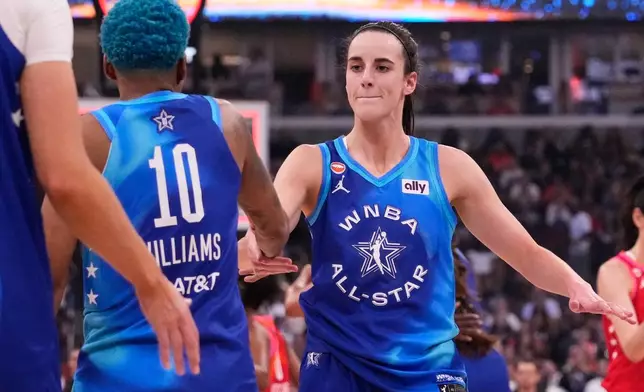 Team Spoon's Caitlin Clark, right, celebrates with Courtney Williams (10) after their team defeated Team Coop in a WNBA All-Star basketball game in Chicago, Saturday, July 25, 2026. (AP Photo/Nam Y. Huh)