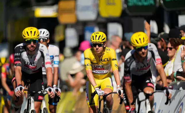 Slovenia's Tadej Pogacar wearing the overall leader's yellow jersey crosses the finish line of the fourth stage of the Tour de France cycling race with start in Carcassonne and finish in Foix, France, Tuesday, July 7, 2026. (AP Photo/Mosa'ab Elshamy)