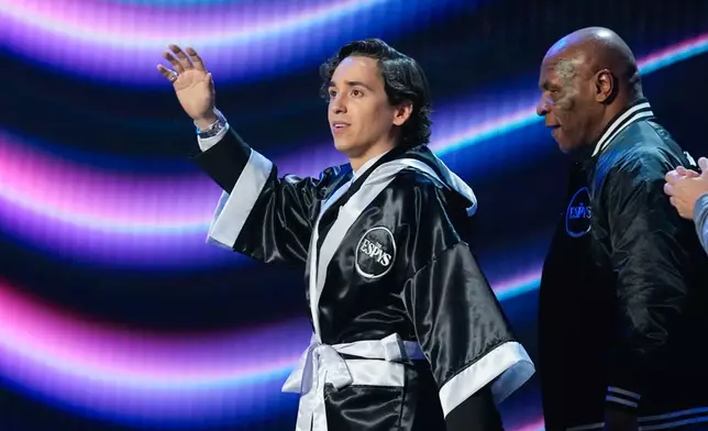 Host Marcello Hernández, left, walks out with Mike Tyson at the ESPY Awards in the David H. Koch Theater at Lincoln Center Wednesday, July 15, 2026, in New York. (AP Photo/Frank Franklin II)
