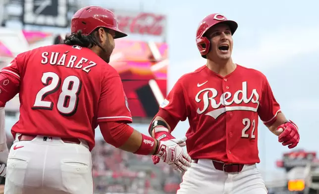 Cincinnati Reds' JJ Bleday, right, celebrates with Eugenio Suárez, left, after hitting a solo home run during the fourth inning of a baseball game against the Philadelphia Phillies in Cincinnati, Wednesday, July 8, 2026. (AP Photo/Carolyn Kaster)