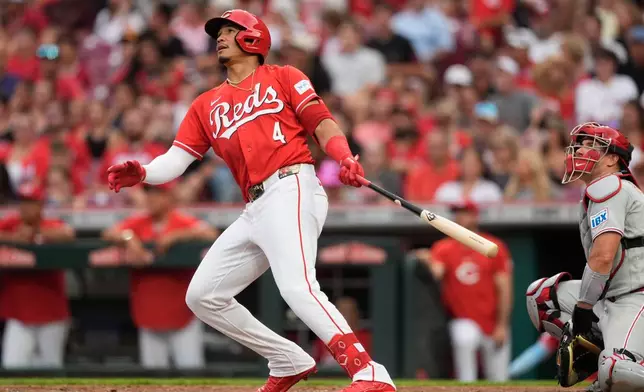 Cincinnati Reds Noelvi Marte watches his solo home run as Philadelphia Phillies catcher J.T. Realmuto is at right run during the fourth inning of a baseball game in Cincinnati, Wednesday, July 8, 2026. (AP Photo/Carolyn Kaster)