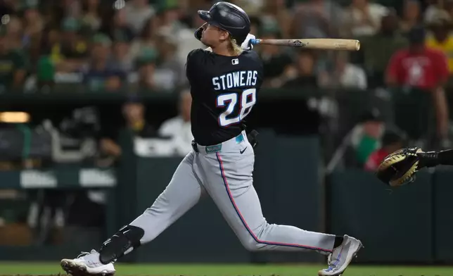 Miami Marlins' Kyle Stowers hits a two-run home run during the eighth inning of a baseball game against the Athletics Friday, July 3, 2026, in West Sacramento, Calif. (AP Photo/Scott Marshall)