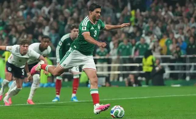 Mexico's Raul Jimenez scores his side's second goal from the penalty spot during the World Cup round of 16 soccer match between Mexico and England in Mexico City, Sunday, July 5, 2026. (AP Photo/Silvia Izquierdo)