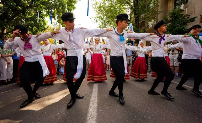 The Kymata ensemble dances during the Kalimera Festival, an event promoting Greek culture, in Bucharest, Romania, Saturday, July 25, 2026. (AP Photo/Andreea Alexandru)