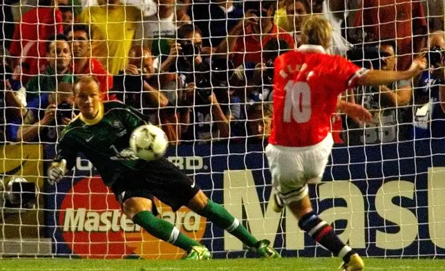 FILE - Norway's Kjetil Rekdal, right, scores the 2-1 with a penalty kick for his team Brazil's goalie Taffarel during the Brazil vs. Norway, Group A, World Cup 98, soccer match at the Velodrome stadium in Marseille, France, on Tuesday, June 23, 1998. (AP Photo/Michel Euler, File)