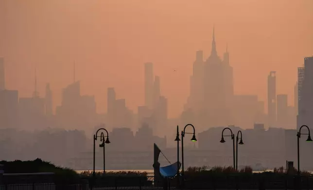 The New York City skyline is seen through a cover of wildfire smoke, in Jersey City, N.J., Friday, July 17, 2026. (AP Photo/Ryan Murphy)