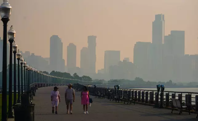 The Jersey City skyline is seen through a cover of wildfire smoke, in Jersey City, N.J., Friday, July 17, 2026. (AP Photo/Ryan Murphy)