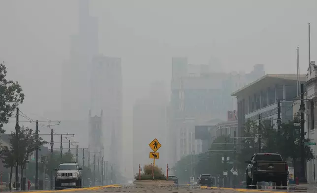 The Detroit city skyline is obscured during poor air quality due to smoke from Canadian wildfires Thursday, July 16, 2026, in Detroit. (AP Photo/Paul Sancya)