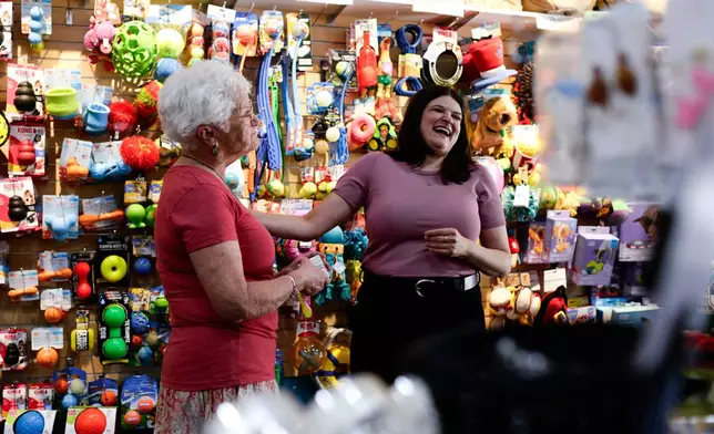 Rep. Haley Stevens, D-Mich., shops at the Decadent Dogs pet store with owner, Roxanne Leder, in South Haven, Mich., on Tuesday, July 7, 2026. (AP Photo/Kristen Norman)