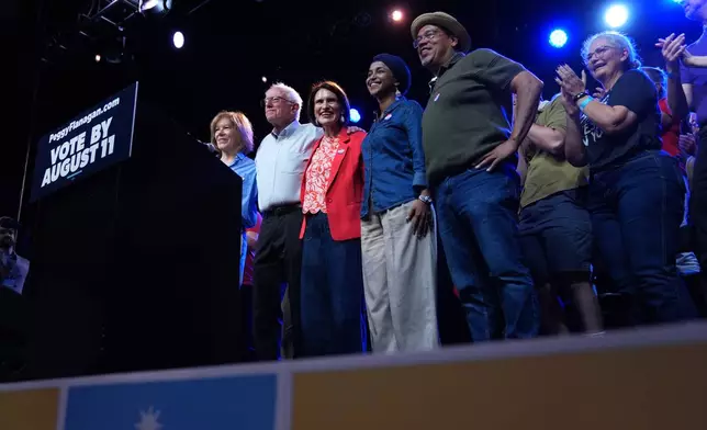 Minnesota Lt. Gov. Peggy Flanagan, center, a Democratic candidate for U.S. Senate, poses with politicians including Sen. Bernie Sanders, I-Vt., second from left, during a campaign rally Monday, July 20, 2026, in Minneapolis. (AP Photo/Ellen Schmidt)