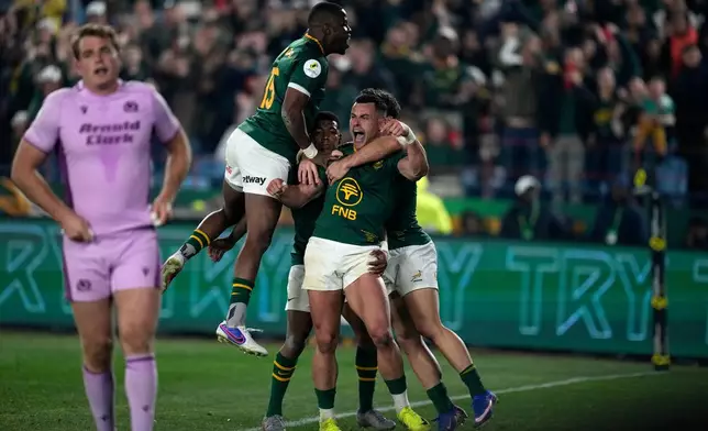 South Africa's Jesse Kriel, center, celebrates with his teammates after scoring a try during the Nations Championship Test rugby match between South Africa and Scotland, in Pretoria, Saturday, July 11, 2026. (AP Photo/Themba Hadebe)