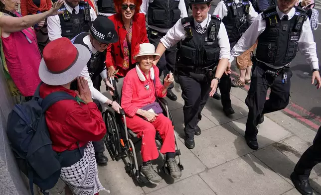A demonstrator is arrested by the police outside the Westminster Magistrates Court in London, Thursday, July 30, 2026, as a plea hearing for 25 people accused of showing support for Palestine Action takes place. (AP Photo/Alberto Pezzali)