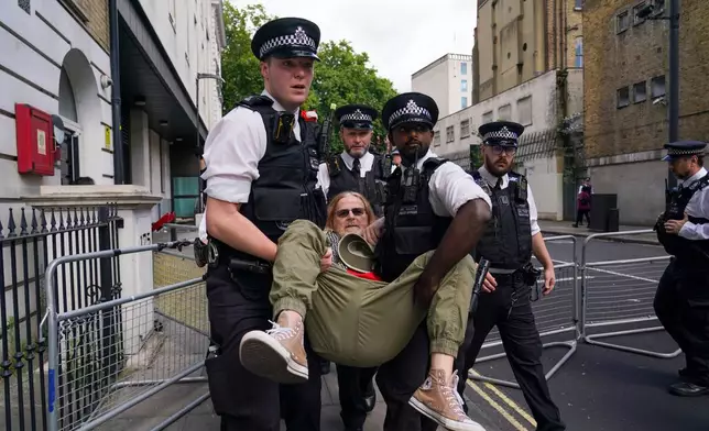 A demonstrator is arrested by the police outside the Westminster Magistrates Court in London, Thursday, July 30, 2026, as a plea hearing for 25 people accused of showing support for Palestine Action takes place. (AP Photo/Alberto Pezzali)