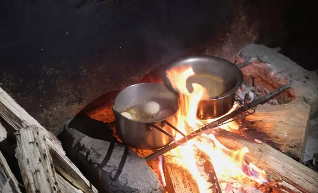 Eggs boil on a hearth in Kohima, capital of the northeastern Indian state of Nagaland, Monday, July 6, 2026. (AP Photo/Yirmiyan Arthur)