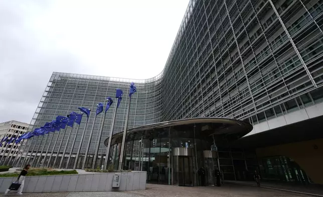 European Union flags flap in the wind outside EU headquarters in Brussels, prior to an announcement regarding Google, Thursday, July 23, 2026. (AP Photo/Virginia Mayo)