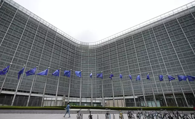 European Union flags flap in the wind outside EU headquarters in Brussels, prior to an announcement regarding Google, Thursday, July 23, 2026. (AP Photo/Virginia Mayo)