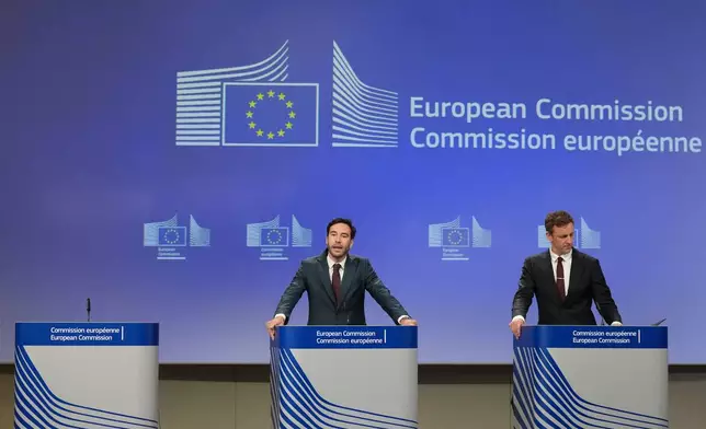 European Commission spokesman Thomas Regnier, left, speaks during a media conference regarding a fine against Google at EU headquarters in Brussels, Thursday, July 23, 2026. (AP Photo/Virginia Mayo)