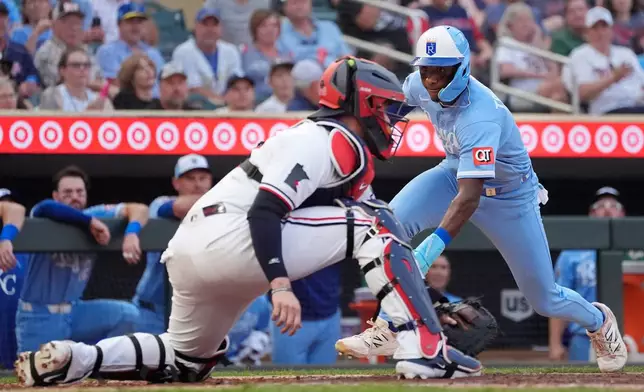 Kansas City Royals' Tyler Tolbert, right, scores on a double by Carter Jensen as Minnesota Twins catcher Ryan Jeffers (27) awaits the throw in the fifth inning of a baseball game Wednesday, July 29, 2026, in Minneapolis. (AP Photo/Bruce Kluckhohn)