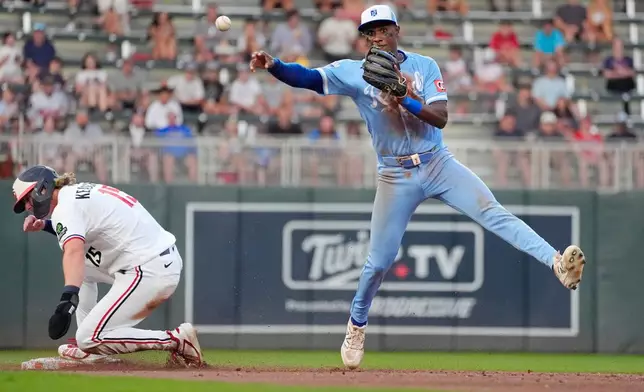 Kansas City Royals right fielder Tyler Tolbert, right, forces out Minnesota Twins' Luke Keaschall (15) but cannot turn the double play on a fielder's choice by Ryan Kreidler in the fifth inning of a baseball game Wednesday, July 29, 2026, in Minneapolis. (AP Photo/Bruce Kluckhohn)