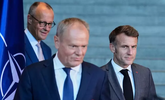 Poland's Prime Minister Donald Tusk, center, French President Emmanuel Macron, right, and German Chancellor Friedrich Merz attend a press conference at the E5 NATO Summit in Berlin, Germany, Wednesday, June 24, 2026. (AP Photo/Ebrahim Noroozi)