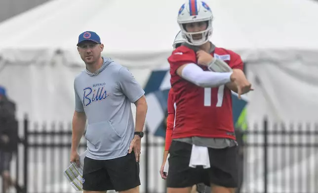 Buffalo Bills head coach Joe Brady, left, watches quarterback Josh Allen throw during practice at the team's NFL football training camp Wednesday, July 29, 2026, in Pittsford, N.Y. (AP Photo/Adrian Kraus)